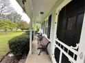 Inviting covered front porch with benches, ideal for relaxing and enjoying the outdoor scenery at 1610 Sprayberry Dr, Marietta, GA 30066