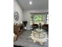 Well-lit living room with bay window, modern decor, and stylish flooring at 539 Rue Montaigne, Stone Mountain, GA 30083