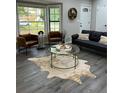 Cozy living area featuring bay window, decor, comfortable seating, and stylish flooring at 539 Rue Montaigne, Stone Mountain, GA 30083