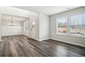Bright living room features hardwood floors, wainscoting and large windows offering lots of natural light at 606 Rodeo Dr, Auburn, GA 30011