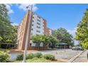 Exterior view of the apartment building with parking; lush trees at 2965 Pharr Nw Ct # 714, Atlanta, GA 30305