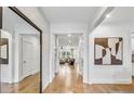 Bright entryway with hardwood floors, white walls, and a view into the living room at 5245 Birch Valley Rd, Cumming, GA 30028