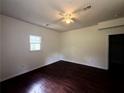 Spacious bedroom with sleek, dark wood floors and a simple ceiling fan at 210 Ormond Sw St, Atlanta, GA 30315
