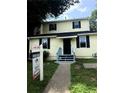 Inviting two-story home with light yellow siding and black shutters at 210 Ormond Sw St, Atlanta, GA 30315