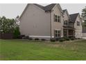 Manicured backyard features green grass, shrubbery, and a fenced perimeter providing a private outdoor space at 505 Mirror Lake Pkwy, Villa Rica, GA 30180
