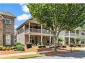Beautiful two-story home boasting a cozy porch and balcony that enhances its curb appeal, surrounded by lush landscaping at 559 Myrle Trace Ln, Suwanee, GA 30024