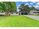 Charming single-story home with a well-maintained lawn and a two-car garage at 2508 Wagon Trce, Duluth, GA 30096