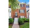 Brick townhome with steps leading to the front door and manicured landscaping at 260 Manning Sw Rd # 76, Marietta, GA 30064