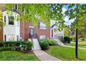Well-maintained townhome with a brick facade, green lawn, and walkway at 260 Manning Sw Rd # 76, Marietta, GA 30064