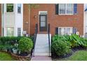 Close up of the front of a townhome with brick facade and landscaped entrance at 260 Manning Sw Rd # 76, Marietta, GA 30064