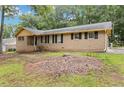 Single-story home with traditional brickwork, black shutters, and a well-maintained front yard at 574 Horseshoe Sw Cir, Lilburn, GA 30047