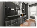 Sleek kitchen features dark gray cabinets, stainless steel appliances, and a subway tile backsplash at 988 Viney Nw Way, Atlanta, GA 30318