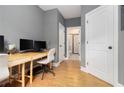 Home office space with wood floors, modern desk and view to adjacent bathroom with shower at 2673 Caruso Way, Atlanta, GA 30339