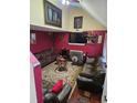 Comfortable living room featuring a fireplace, high ceilings, plush sofas, and a patterned rug at 7073 Stonecreek Dr, Douglasville, GA 30134