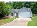 Charming single-story home with gray siding, a paved driveway and a well-maintained lawn at 784 Crestworth Xing, Powder Springs, GA 30127