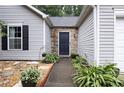 Close up of front door and walkway featuring landscaping at 784 Crestworth Xing, Powder Springs, GA 30127