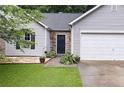 Close-up of home featuring stone accents, a well manicured yard, and a dark front door at 784 Crestworth Xing, Powder Springs, GA 30127