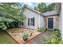 Landscaped front yard with stone accents and a charming walkway to the front door at 784 Crestworth Xing, Powder Springs, GA 30127