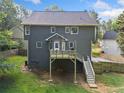 View of back of the home featuring a deck with stairs leading to the yard, and a fenced in yard at 150 Kensley Way, Dallas, GA 30157