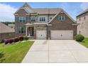 Charming brick two-story home featuring a two-car garage and well-maintained landscaping at 4154 Hawking Dr, Suwanee, GA 30024