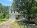 Charming two-story home with a well-manicured lawn and mature tree offering shade and curb appeal at 4164 River Shoals Ct, Duluth, GA 30097