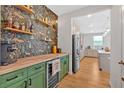 Stylish bar area with vibrant wallpaper, open shelving, wooden countertops and view of the kitchen at 87 Rushing View Gln, Dallas, GA 30157