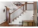 Bright foyer showcasing the staircase with a dark banister and an adjacent sliding barn door at 2316 Defoors Ferry Nw Rd, Atlanta, GA 30318