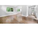 Spacious living room with hardwood floors, white trim, and a view of lush outdoor scenery at 3068 Cherry Blossom Ln, Atlanta, GA 30344