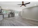 Bright kitchen boasts white cabinets, stainless steel appliances, and modern gray flooring at 4176 King Edward Dr, Douglasville, GA 30135