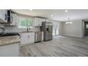 Well-lit kitchen with granite countertops, stainless appliances, and white subway tile backsplash at 4176 King Edward Dr, Douglasville, GA 30135