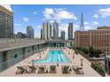 Rooftop pool deck with city views, lounge chairs, and well-maintained landscaping in a modern setting at 845 Spring Nw St # Ph 5, Atlanta, GA 30308
