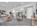 Open-concept living space featuring neutral decor, recessed lighting and wood-look flooring at 4890 Old Briar Trl, Douglasville, GA 30135