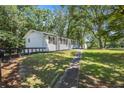 View of the back of the home with a walkway leading to the backyard at 4890 Old Briar Trl, Douglasville, GA 30135