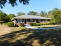 Traditional brick home with a covered front porch, manicured bushes, and a lush green lawn at 893 Andrews Dr, Conyers, GA 30012
