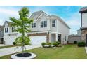 Stylish two-story home featuring a tidy front yard, attached two-car garage, and a welcoming entrance at 149 Woodhouse Cir, Acworth, GA 30102