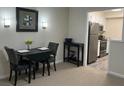 Cozy dining area with modern lighting, stylish seating, and view into the stainless steel kitchen appliances at 475 Mount Vernon Ne Hwy # C229, Atlanta, GA 30328