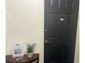 Entryway featuring a black door, half-round table with decorative vase, and building information at 475 Mount Vernon Ne Hwy # C229, Atlanta, GA 30328
