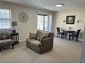 Relaxing living room with a comfortable sofa, stylish accent chair, and a sliding door to a patio at 475 Mount Vernon Ne Hwy # C229, Atlanta, GA 30328