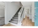 Bright entryway featuring a staircase with plush carpet, light wood floors, and a freshly painted interior at 56 Carlane Cir, Bowdon, GA 30108