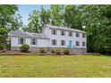 Exterior view of home with a metal roof, symmetrical windows, and a well-manicured front lawn at 56 Carlane Cir, Bowdon, GA 30108