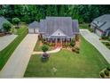 Aerial view displays a single-story brick home and lush yard at 3468 Aberrone Pl, Buford, GA 30519