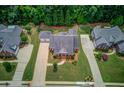 An aerial view showcases a home's manicured lawn and professional landscaping at 3468 Aberrone Pl, Buford, GA 30519