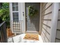 Charming front entrance with a welcoming mat and a decorative wreath, enhancing curb appeal at 4149 Spring Cove Dr, Duluth, GA 30097