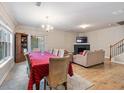 Open-concept living room features hardwood floors, a fireplace, and a large dining table at 805 Pleasant Hill Nw Rd # 231, Lilburn, GA 30047