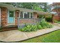 Inviting front porch with a blue door and lush landscaping at 890 Oriole Se Ln, Marietta, GA 30067