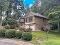 Two-story house nestled among trees with stone accents and a two-car garage at 4801 Deer Chase, Powder Springs, GA 30127
