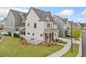 View of home's side yard with lawn and view of other homes in neighborhood at 1010 Fendley St, Woodstock, GA 30188