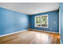 Cozy bedroom with hardwood floors and a large window with natural light at 3185 Oak Ridge Ln, Loganville, GA 30052