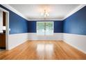 Dining room featuring hardwood floors, white trim, textured ceiling, and decorative lighting at 3185 Oak Ridge Ln, Loganville, GA 30052