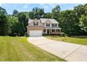 Charming two-story home with brick facade, attached garage, and a well-manicured front yard at 3185 Oak Ridge Ln, Loganville, GA 30052
